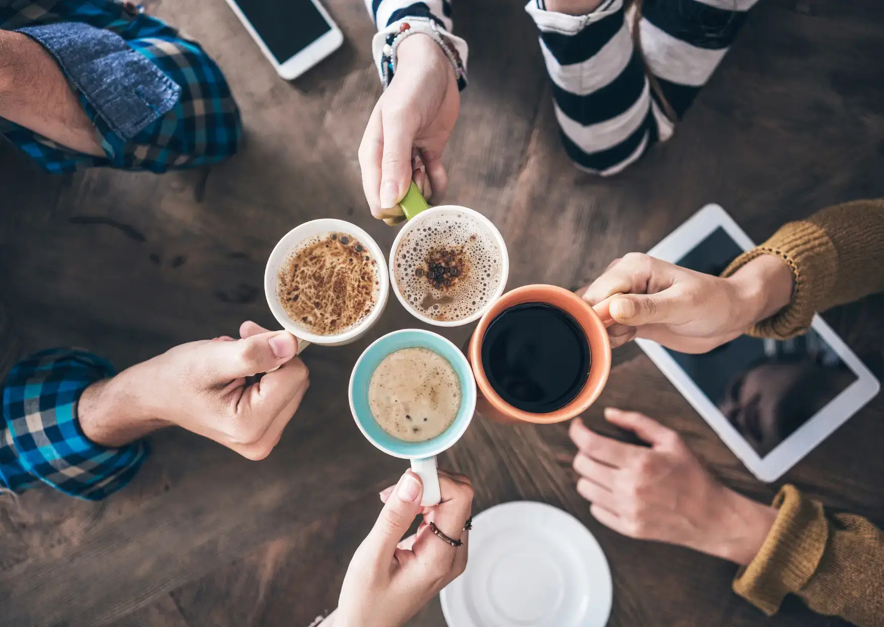 4 people cheers with coffee